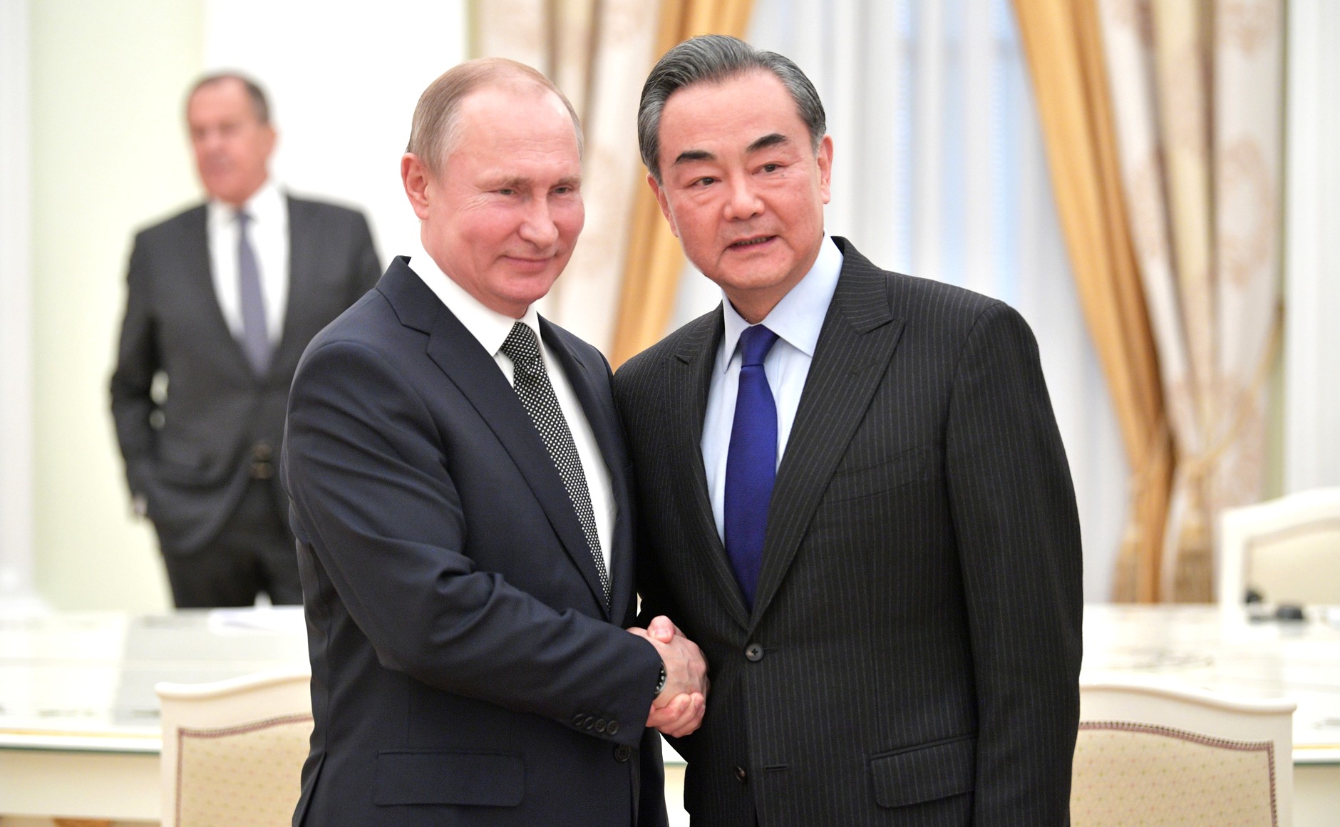Chinese Foreign Minister Wang Yi with Russian President Vladimir Putin |