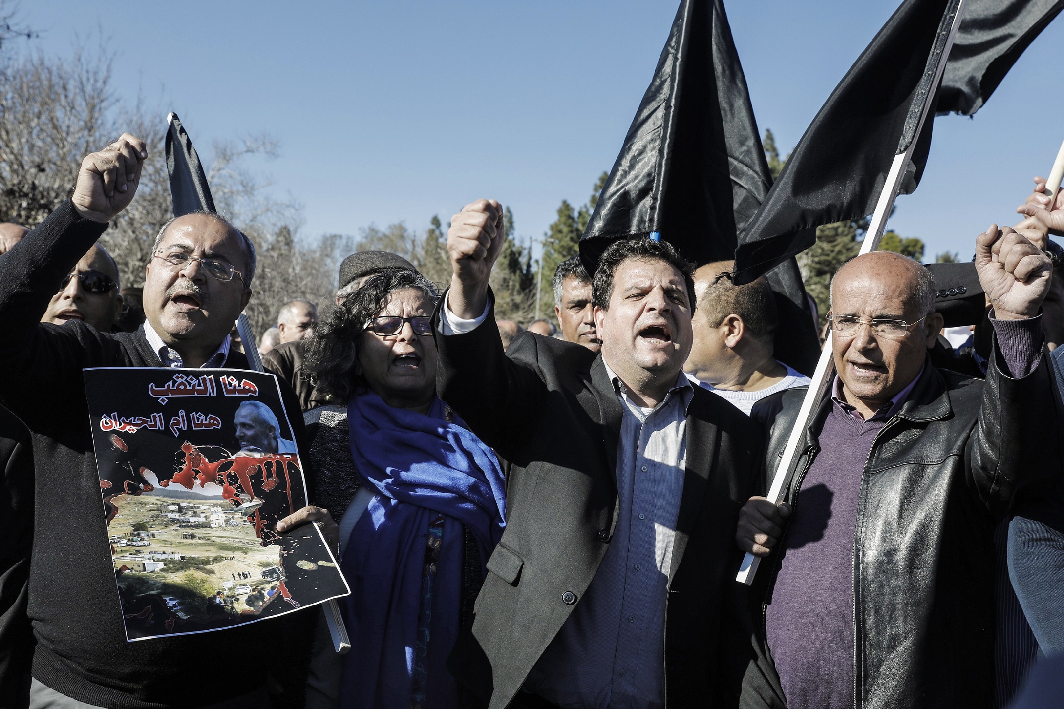 MK Ahmad Tibi (l) and United List head Ayman Odeh (c) in a protest in Jerusalem against house demolitions by Israeli authorities in Arab neighborhoods, January 23, 2017. Photo: Menahem Kahana / AFP