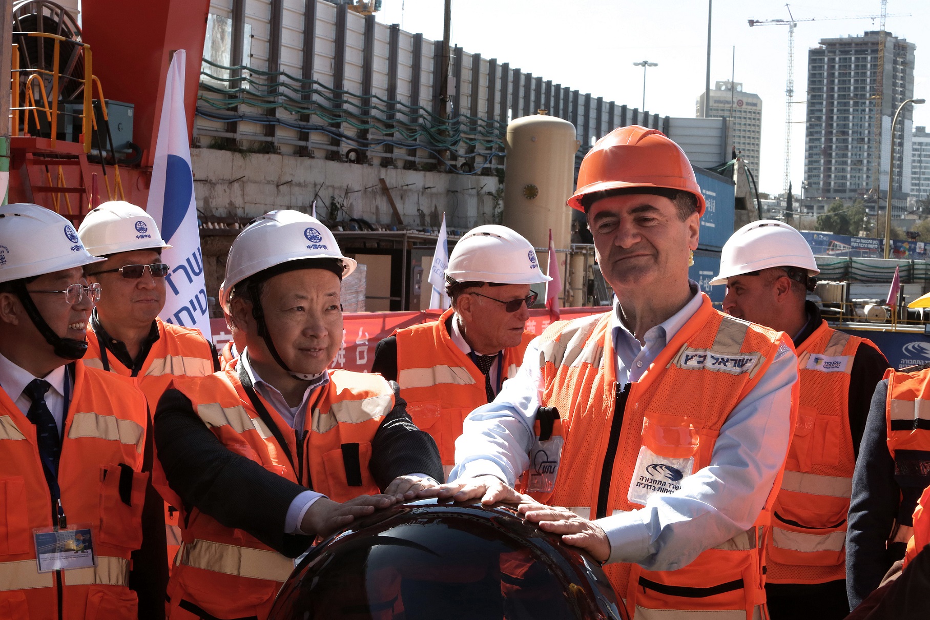 Israeli Minister of Transport, Yisrael Katzis (C-R) and Chinese Ambassador to Israel Zhan Yongxin (C-L) activate a digging machine at a construction site on February 19, 2017 in the Israeli city of Ramat Gan, east of Tel Aviv, where the first tunnel for the Tel Aviv underground subway system is being dug. The TBMs (Digging Machine), which is manufactured by China and used at the site, weighs 900 tons and is 115 meters long. MENAHEM KAHANA / AFP