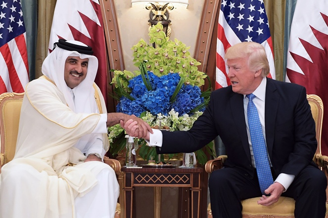 US President Donald Trump (R) shaking hands with Qatar's Emir Sheikh Tamim Bin Hamad Al-Thani, during a bilateral meeting at a hotel in the Saudi capital Riyadh. May 21, 2017