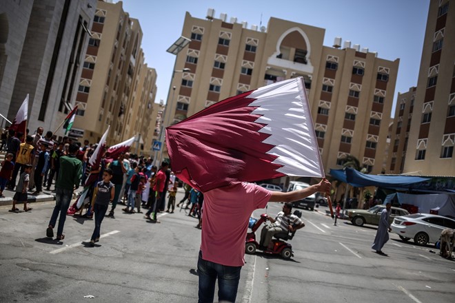 A group of Palestinian hold Qatar flags and banners during a demonstration in support of Qatar, in Khan Yunis, Gaza on June 09, 2017.