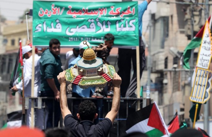 Jordanians carry a model of the Dome of the Rock mosque during a demonstration, called for by the Islamic Action Front, in Amman following friday prayers on July 21, 2017, to protest against new Israeli security measures implemented at the holy site, which include metal detectors and cameras, following an attack that killed two Israeli policemen the previous week. Palestinian protesters clashed with Israeli forces outside Jerusalem's Old City as tensions mounted over new security measures at a highly sensitive holy site and prompted police to restrict access for Muslim prayers.