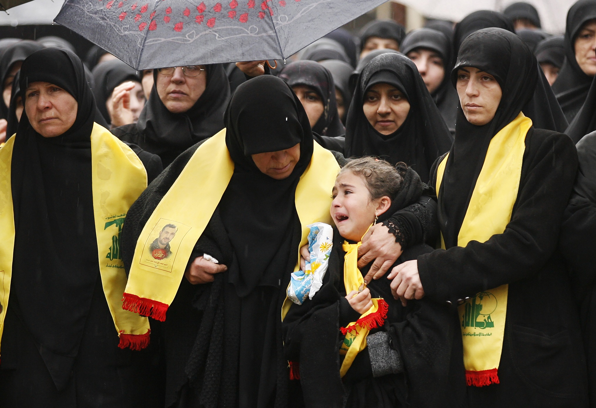 Mourners attend the funeral of Ali Ahmed Sabra, a member of Lebanon's militant Shiite Muslim movement Hezbollah who was killed in combat alongside Syrian government forces in Aleppo, on February 6, 2016, in the Lebanese village of Jibshit, about 50 kilometres south of the capital Beirut