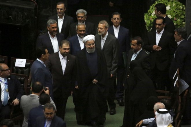 Iran's President Hassan Rouhani (C) greets visitors as he arrives for his swearing in ceremony in Tehran, on August 5, 2017. Rouhani warned the US against tearing up the nuclear deal as he was inaugurated for a second term, but he also faces challenges closer to home amid accusations he is rolling over to conservatives.