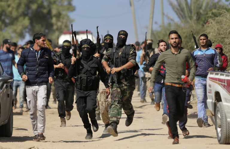 Palestinian fighters from the Islamic Jihad movement attend the funeral of comrades killed in an Israeli operation to blow up a tunnel stretching from the Gaza Strip into Israel during their funeral at the Bureij refugee camp, in central Gaza, on October 31, 2017.