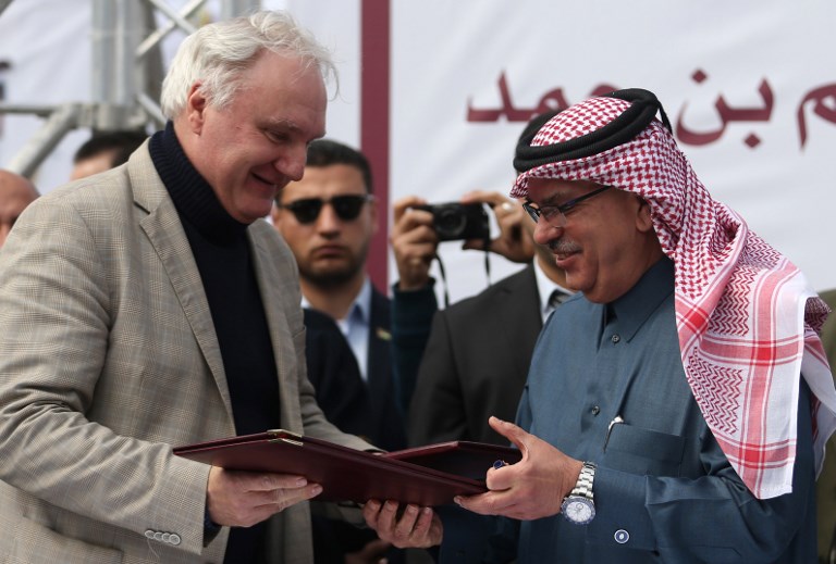Qatari Ambassador to Gaza Mohammed al-Emadi and Director of UNRWA Operations in Gaza Matthias Schmale exchange documents after Qatar signed an agreement to provide a nine million dollar humanitarian relief grant to residents of the Gaza Strip following a press conference at the Dar al-Shifa hospital in Gaza City on February 19, 2018.