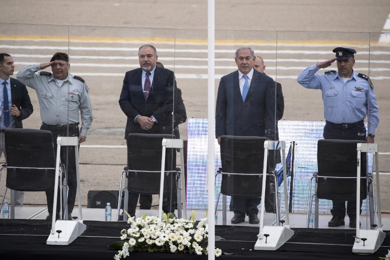 (From R to L) Israeli Air Force Commander, Israeli Prime Minister , Defence Minister and Chief of Staff stand for their national anthem during the graduation ceremony of Israeli air force pilots at the Hatzerim Israeli Air Force base in the Negev desert, near the southern Israeli city of Beer Sheva, on December 27, 2017.