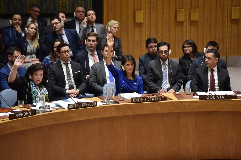 British Ambassador to the UN Karen Pierce (L) and US Ambassador to the UN Nikki Haley (C) vote during a UN Security Council meeting, at the United Nations Headquarters in New York, on April 14, 2018.