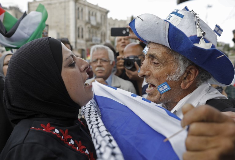 An Israeli man confronts a Palestinian woman at Damascus gate in Jerusalem on May 13, 2018.