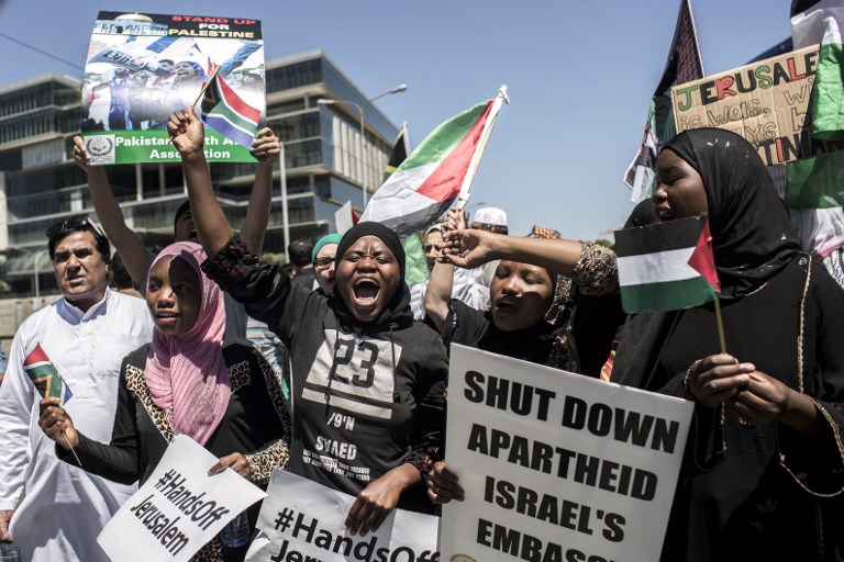 Members of pro-Palestinian groups, the Young Communist League, the Ahmed Kathrada Foundation, civil society groups and others demonstrate outside the US Consulate General in Sandton, Johannesburg, on December 14, 2017.