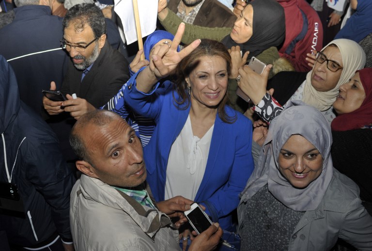 Tunisian Ennahdha party member Souad Abderrahim (C) jubilates after winning the municipal elections in front of the movement's headquarters in Tunis late on May 6, 2018.