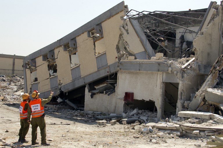 Israel's Home Front Command soldiers inspect destroyed buildings during an exercise simulating the evacuation of buildings hit by missiles in Kiryat Malakhi, southern Israel, on June 22, 2011 as part of a massive nationwide defence exercise.