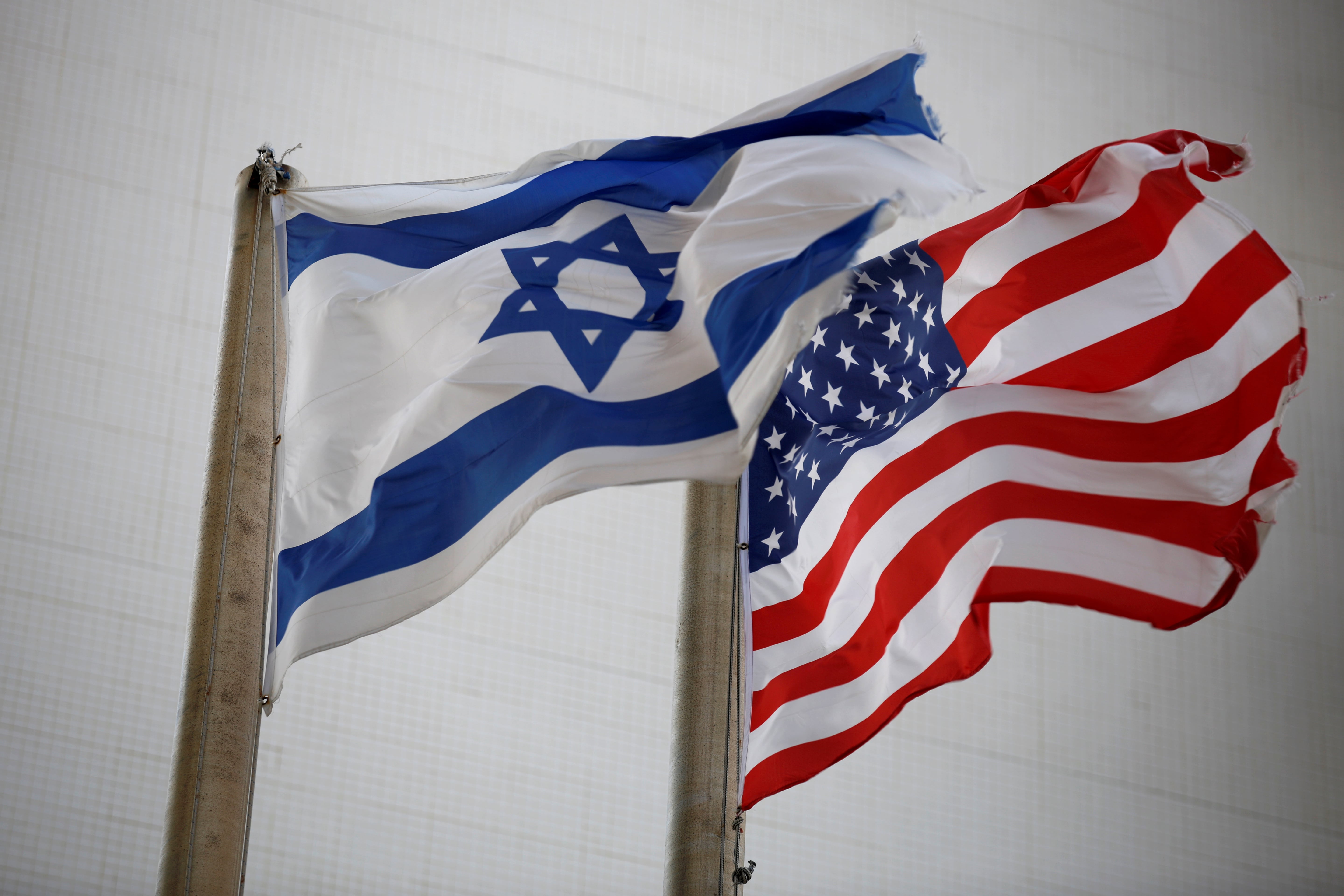 The American and the Israeli national flags can be seen outside the U.S Embassy in Tel Aviv, Israel December 5, 2017.