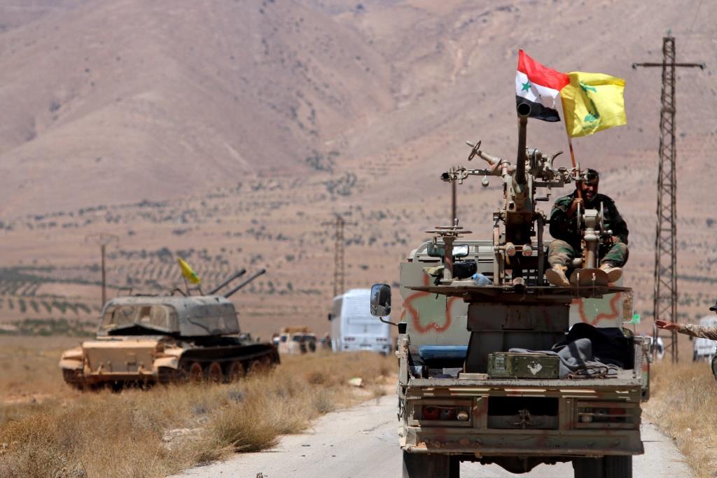 Hezbollah and Syrian flags flutter on a military vehicle in Western Qalamoun, Syria. August 28, 2017.