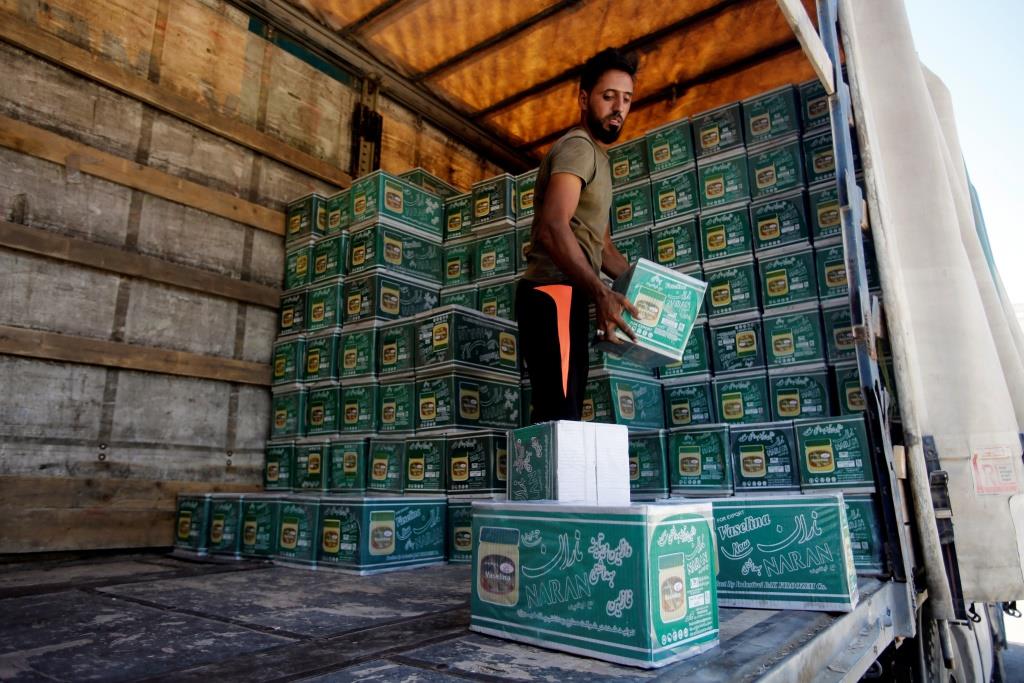 An Iraqi worker unloads a truck from Iran, loaded with cosmetics, in Baghdad, Iraq August 17, 2018.