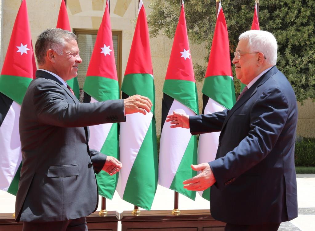 Palestinian president Mahmoud Abbas (R) greets King Abdullah II of Jordan as he arrives to meet with him at the Royal Palace in Amman, Jordan August 8, 2018.