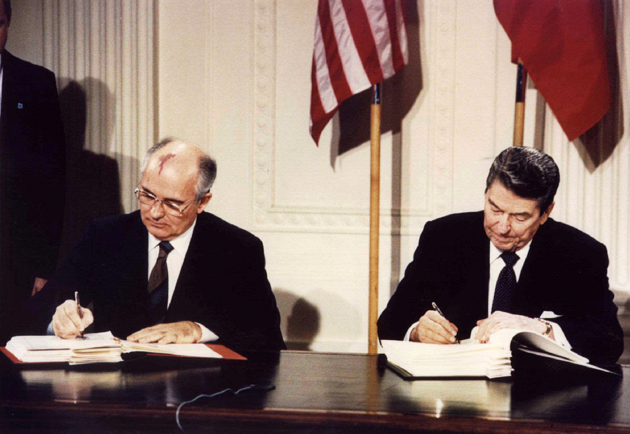 President Ronald Reagan (R) and Soviet President Mikhail Gorbachev sign the Intermediate-Range Nuclear Forces (INF) treaty at the White House, Washington, on December 8 1987.