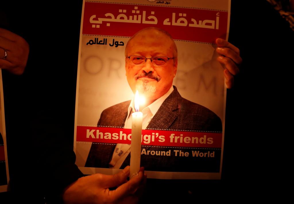 A demonstrator holds a poster with a picture of Saudi journalist Jamal Khashoggi outside the Saudi Arabia consulate in Istanbul, Turkey October 25, 2018.