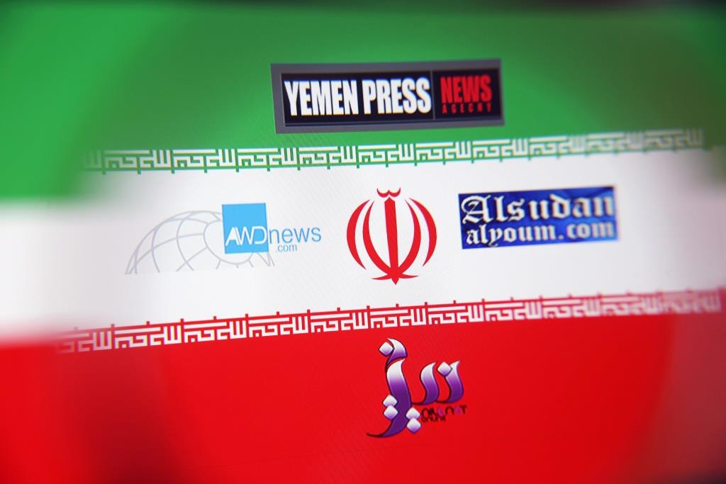 The logos for the Yemen Press News Agency, Sudan Today, Nile Net Online and AWDnews websites are seen against an Iranian flag in a picture illustration taken November 29, 2018. Picture taken November 29, 2018.
