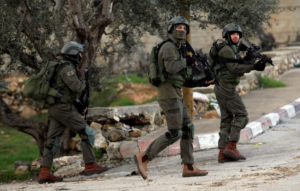 Israeli forces walk during a raid in Ramallah in the West Bank December 13, 2018.