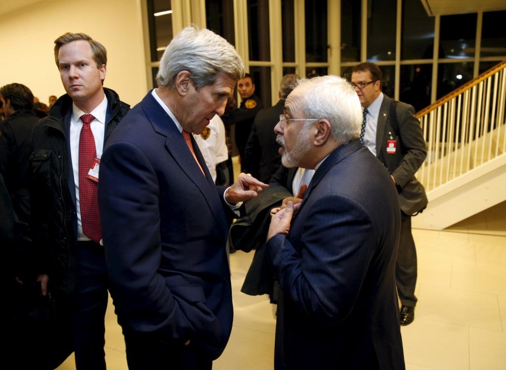 U.S. Secretary of State John Kerry talks with Iranian Foreign Minister Javad Zarif after the International Atomic Energy Agency (IAEA) verified that Iran has met all conditions under the nuclear deal, in Vienna January 16, 2016.