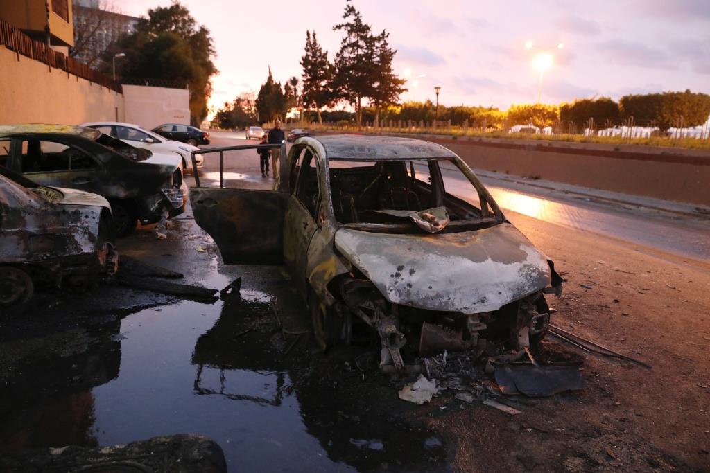Burned cars are seen at the site of the headquarters of Libya's Foreign Ministry after suicide attackers hit in Tripoli, Libya. December 25, 2018.