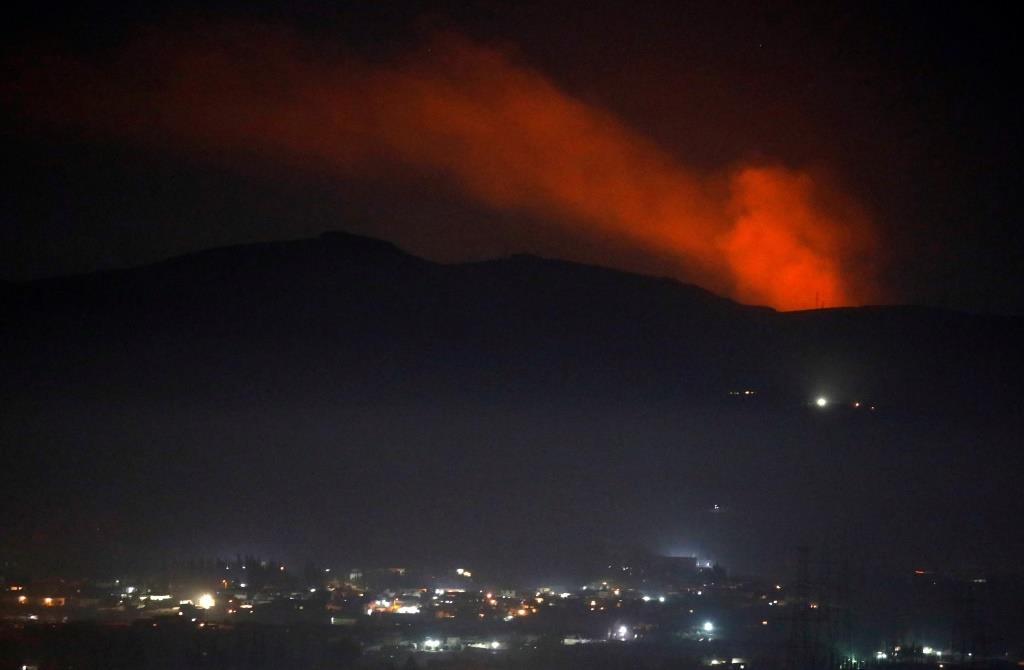 Smoke rises past a mountain as seen from Damascus countryside, Syria December 25, 2018.