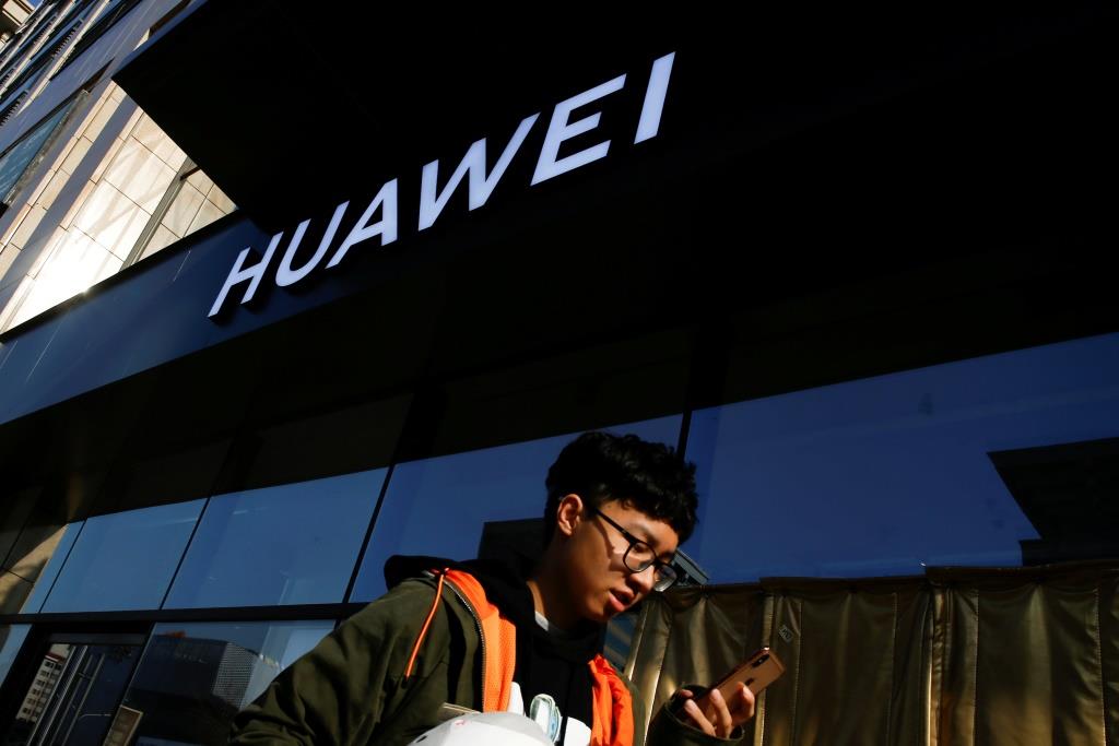 FILE PHOTO: A man walks past a Huawei shop in Beijing, China, December 19, 2018.