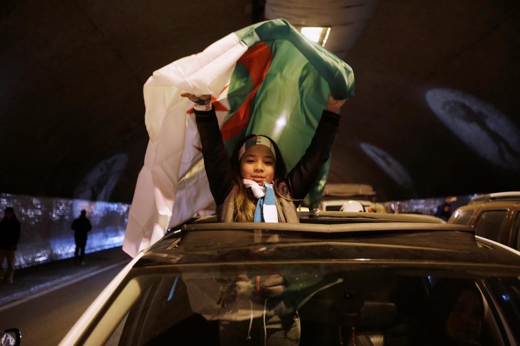 A girl celebrates on the streets after President Abdelaziz Bouteflika announced he will not run for a fifth term, in Algiers, Algeria March 11, 2019.