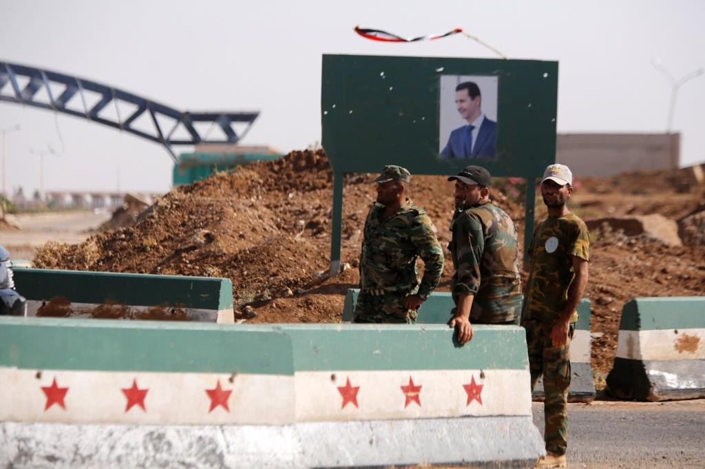 Syrian soldiers stand at the Nasib border crossing with Jordan in Deraa, Syria July 7, 2018.