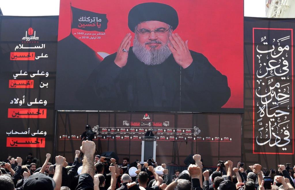 Lebanon's Hezbollah leader Sayyed Hassan Nasrallah gestures as he addresses his supporters via a screen during last day of Ashura, in Beirut, Lebanon September 20, 2018.