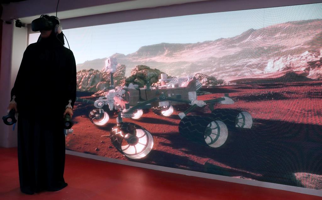 A woman experiencing Mars through virtual reality goggles at Alef Education technology company pod in Dubai, United Arab Emirates February 27, 2018.