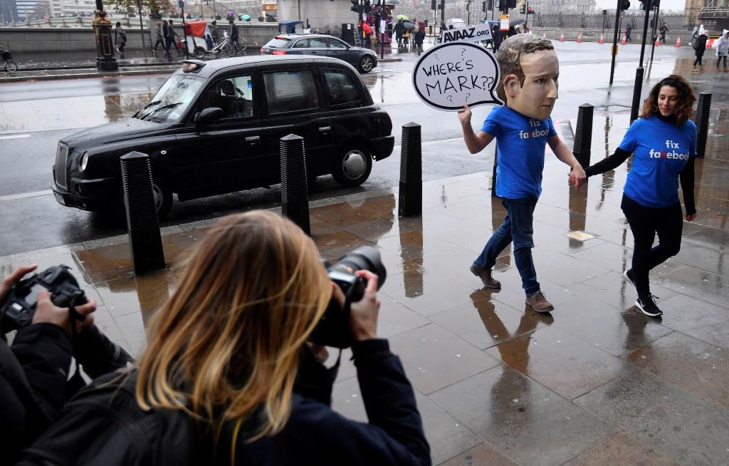 A campaigner from a political pressure group wears an oversized mask of founder and CEO of Facebook Mark Zuckerberg after he failed to attend a meeting on fake news held by Parliament's Digital, Culture Media and Sport committee in London November 27, 2018.