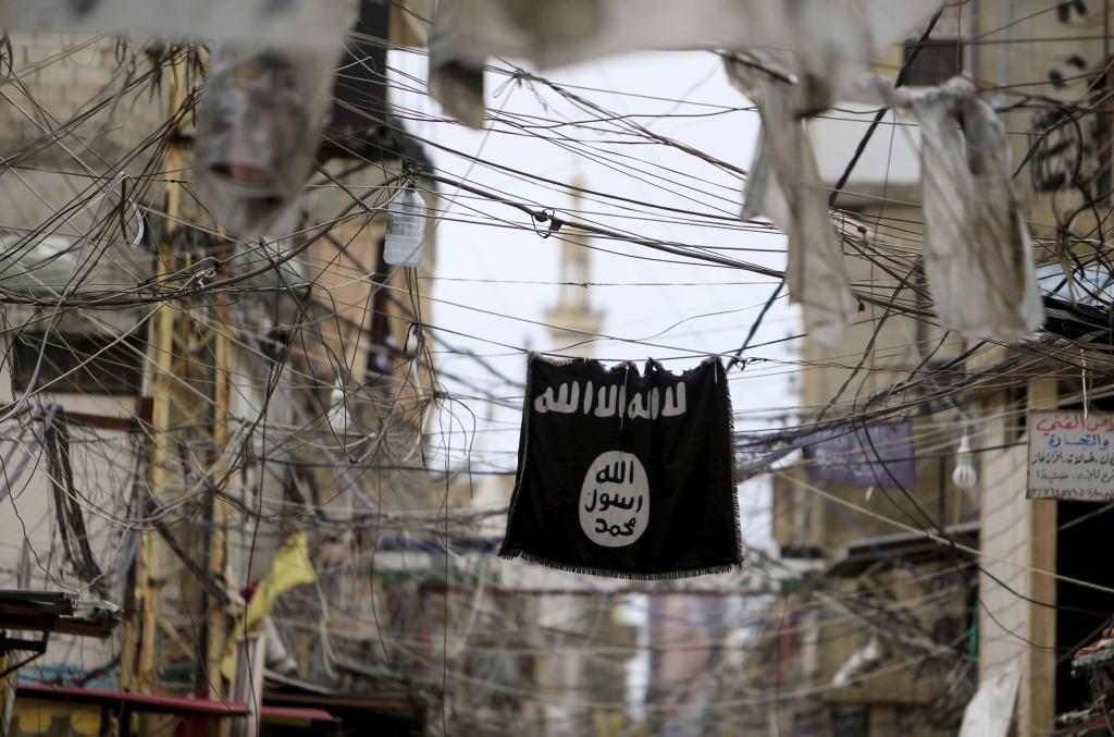 An Islamic State flag hangs amid electric wires over a street in Ain al-Hilweh Palestinian refugee camp, near the port-city of Sidon, southern Lebanon January 19, 2016.