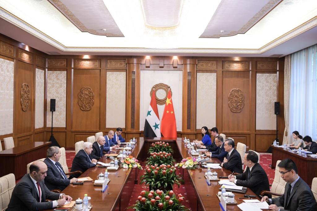 Syrian Foreign Minister Walid Muallem speaks with Chinese Foreign Minister Wang Yi during a meeting at Diaoyutai State Guesthouse in Beijing on June 18, 2019.
