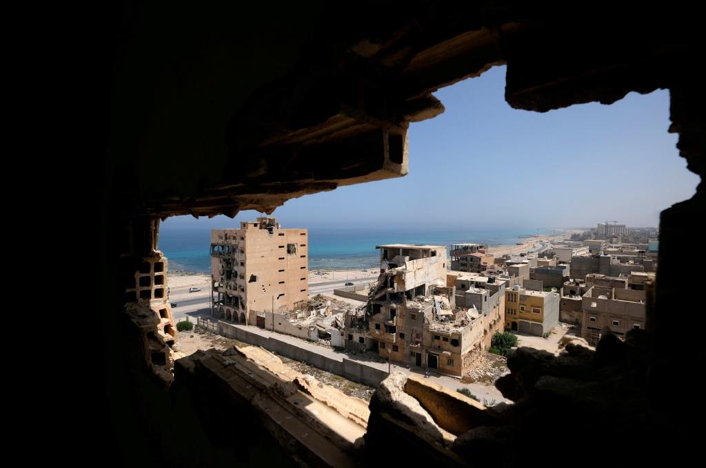 Destroyed buildings are seen through a hole in Benghazi lighthouse after it was severely damaged by years of armed conflict, in Benghazi, Libya July 10, 2019 .