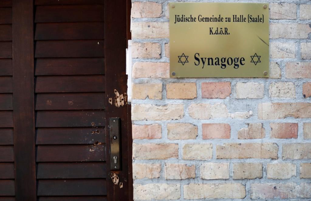 The damaged door of a synagogue is seen in Halle, Germany October 10, 2019, after two people were killed in a shooting.
