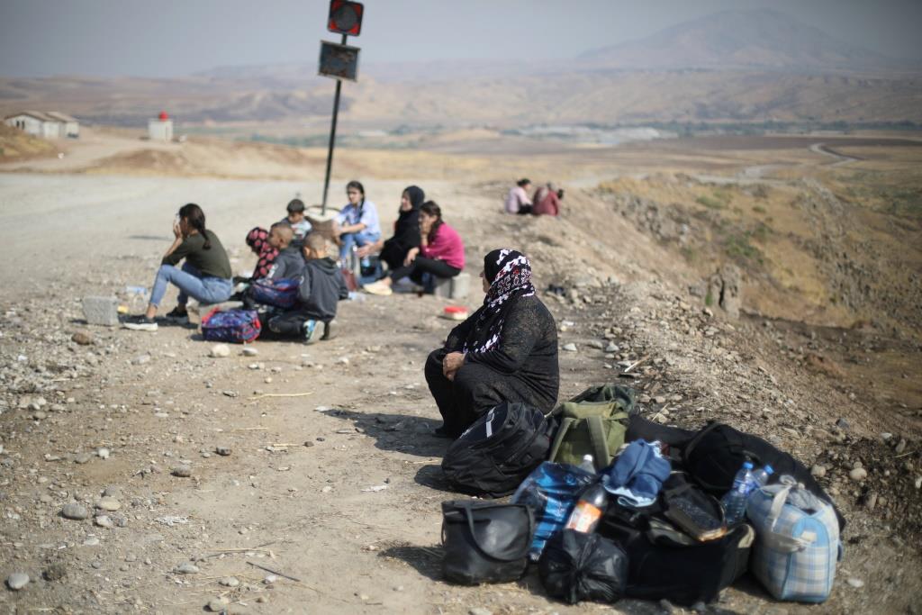 Displaced Kurds stuck at a border after a Turkish offensive in northeastern Syria, wait to try cross to the Iraqi side, at the Semalka crossing, next Derik city, Syria, October 21, 2019.