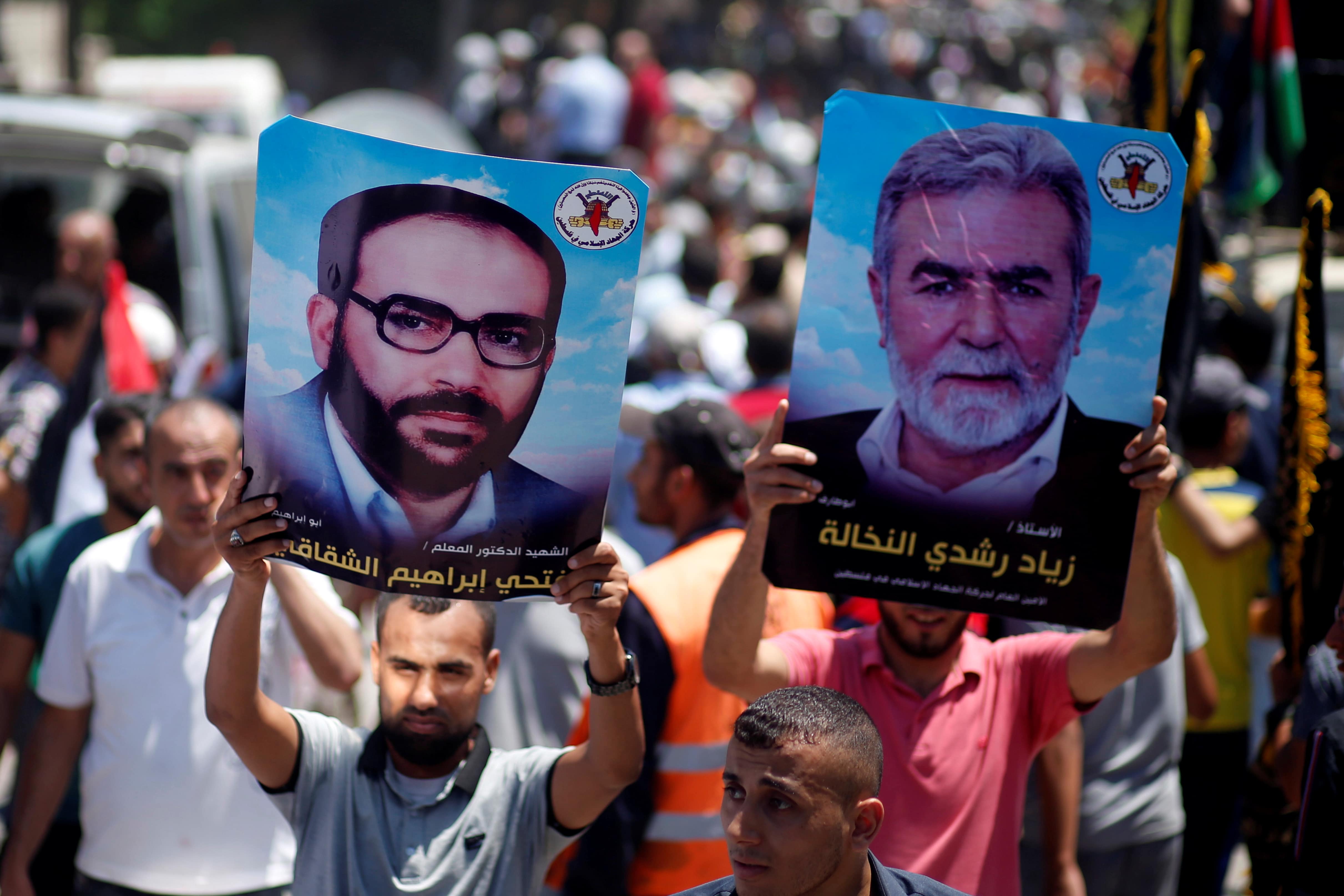 Palestinian demonstrators hold posters of late Islamic Jihad founder Fathi Shaqaqi and Islamic Jihad Chief Ziyad Al-Nakhaleh, in Gaza City, June 26, 2019.