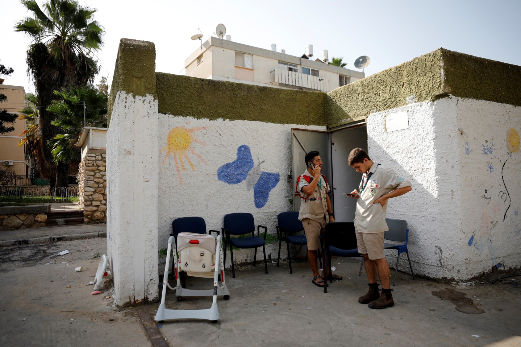 Scouts use their mobile phones while standing near a bomb shelter as a spike in cross-border violence with Gaza continues, in Ashkelon, southern Israel November 13, 2019.