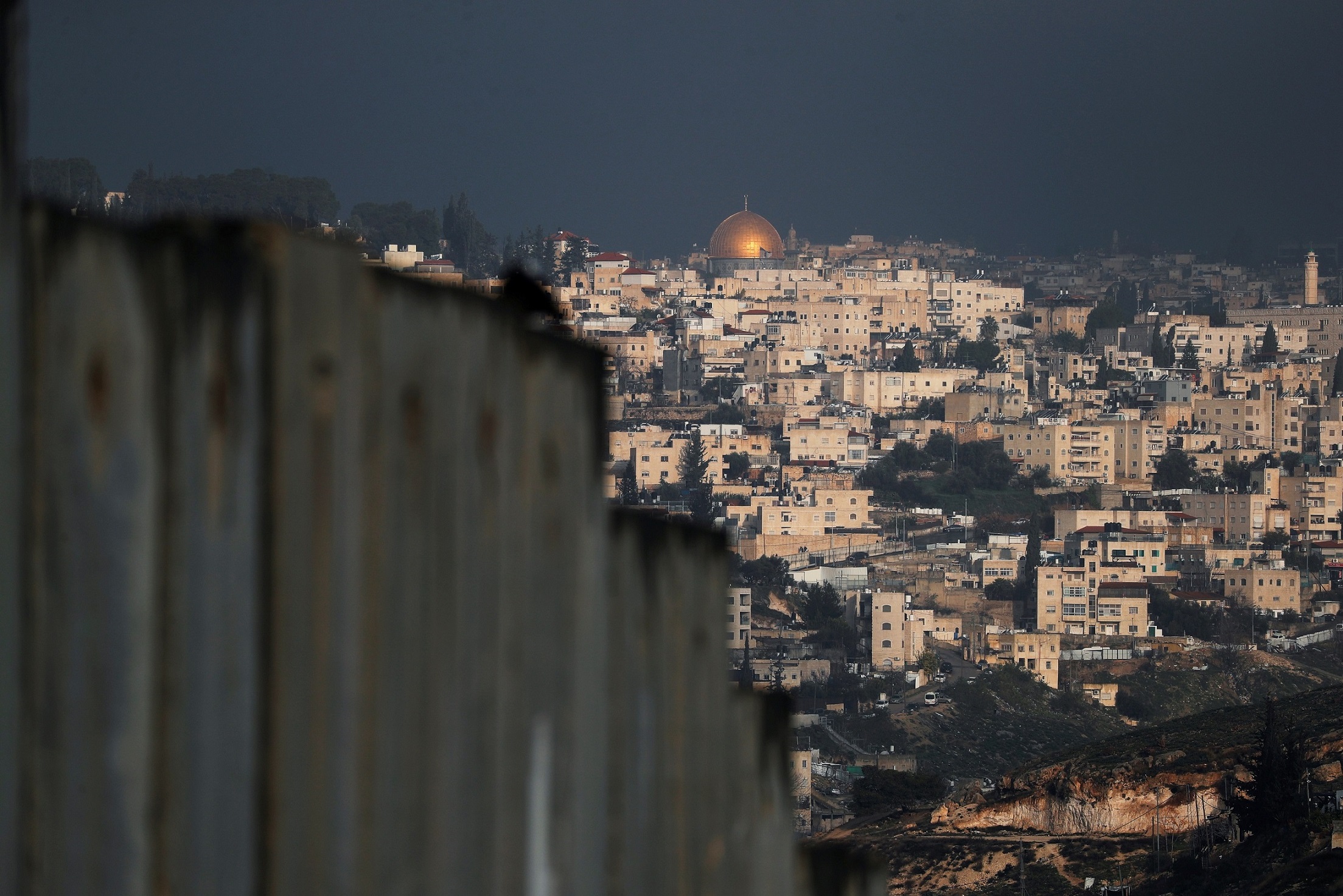 A general view picture shows the Dome of the Rock in Jerusalem's Old City in the background and part of the Israeli barrier in the foreground, as seen from the Palestinian town of Abu Dis in the Israeli-occupied West Bank, east of Jerusalem January 29, 2020.