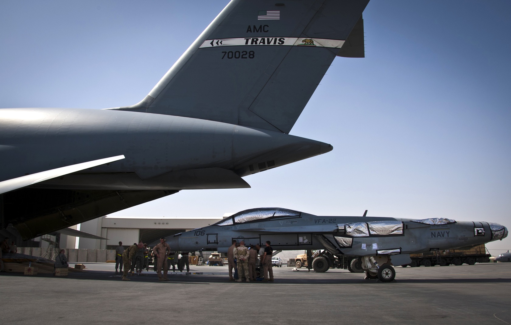 Airmen look over a load plan as they prepare to load an F/A-18 Super Hornet onto a C-5 Galaxy on Aug. 18, 2011, at Kandahar Airfield, Afghanistan. This marked the first time a U.S. fighter jet had been successfully loaded into a cargo aircraft for transport back to the U.S. The Airmen are assigned to the 451st Expeditionary Logistics Readiness Squadron at Kandahar Airfield and the 22nd Airlift Squadron at Travis Air Force Base, Calif.