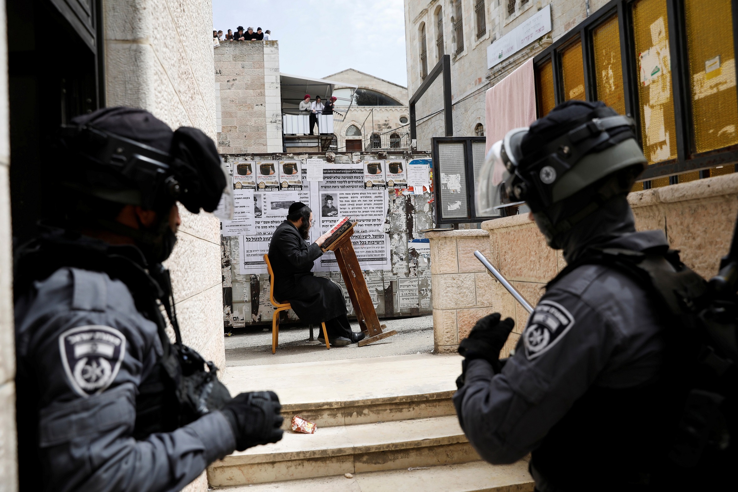 An ultra-Orthodox Jewish man prays after he was removed by Israeli police from a synagogue which they closed as they enforce restrictions of a partial lockdown against the coronavirus disease (COVID-19) in Mea Shearim neighbourhood of Jerusalem March 30, 2020