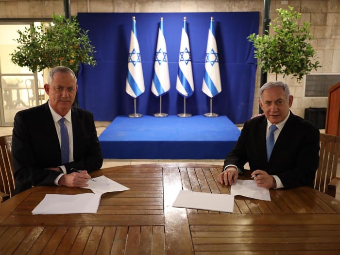 PM Benjamin Netanyahu and head of Blue and White Benny Gantz sign the coalition agreements