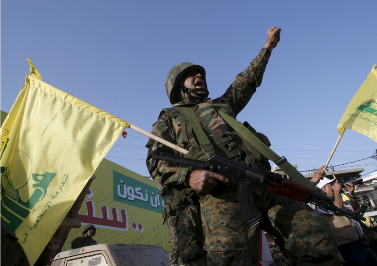 A Hezbollah member reacts while Nasrallah talks on a screen during a televised speech at a festival celebrating Resistance and Liberation Day, in Nabatiyeh
