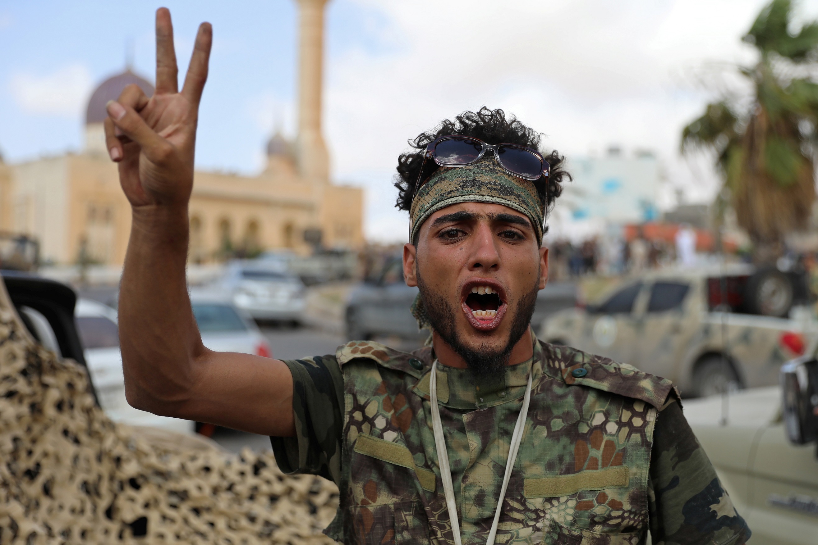A fighter loyal to Libya's internationally recognised government celebrates after regaining control over Tarhouna city